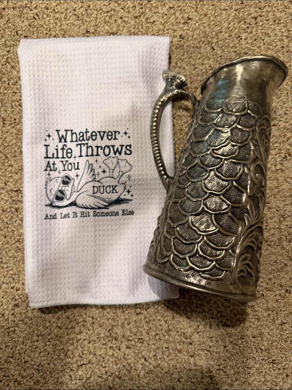 Stainless Steel Pitcher and White Waffle Weave Kitchen Towel